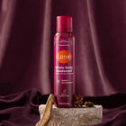 Lume spray deodorant on top of a rock and surrounded by spices, with luxe fabric in the background.