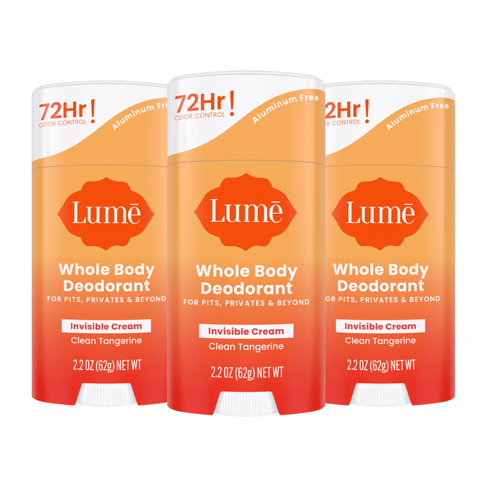 Three orange Lume cream deodorant sticks in the scent Clean Tangerine