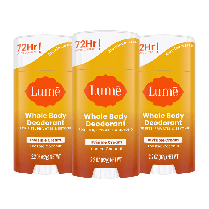 Three orange Lume cream deodorant sticks in the scent Toasted Coconut