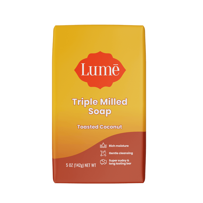 Bright orange Lume toasted coconut scented soap bar against a white background